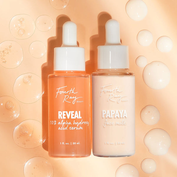 Renew ColourPop Skin Refining Duo shows two Fourth Ray Beauty 1 fl oz glass dropper bottles - Reveal 10% AHA serum (orange) and Papaya Face Milk (creamy peach) - standing side by side on a glossy peach background with floating serum bubbles.