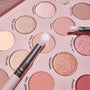 Total Smokeshow ColourPop Shadow Palette & Brush Set featuring two fluffy brushes sweeping over matte nude “Say It’s True” and shimmery rose-gold “Romance” pans, with shades like Every Rose, Alone, and On the Edge in a blush pink tray.