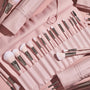 Total Smokeshow brushes fanned in a blush-pink roll-up case, featuring soft pink bristles, silver ferrules, and face and eye tools (powder, blending, angled, spoolie) from the ColourPop Shadow Palette & Brush Set, styled on a matching pink backdrop.