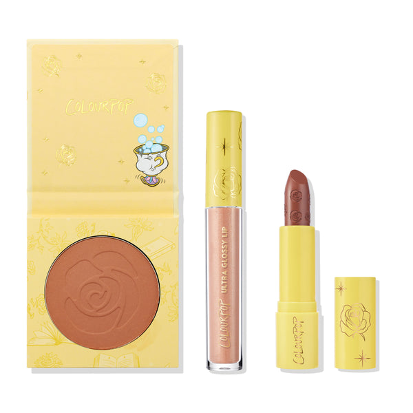 Kind at Heart ColourPop Lip & Cheek Set displayed on a white background, featuring a yellow compact with rose‑embossed warm terracotta cheek color, a pink‑pearl Ultra Glossy Lip, and a rose‑stamped nude lipstick in matching yellow packaging.