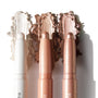 Three ColourPop Shadow Stix Metallic Neutrals swatched side by side, displaying creamy high-shine payoff - icy pearl, champagne peach, and bronze taupe - twist-up eyeshadow sticks with rounded tips on a clean white background.
