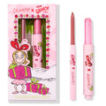 ColourPop Pinky Who So Juicy Plumping Gloss Stick, shown uncapped in shimmery pink, pairs with a coordinating nude-pink lip liner beside festive ColourPop x The Grinch packaging - twist-up plumping gloss for juicy shine.
