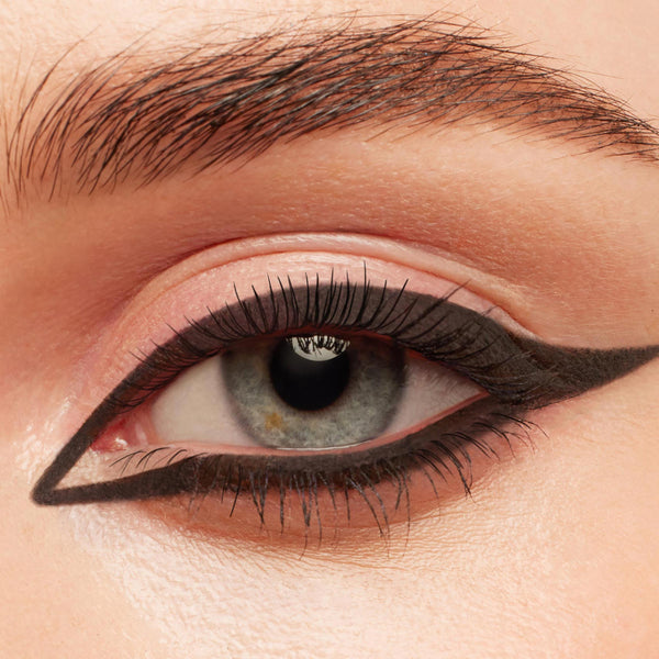 New BFF Crème Gel Liner tracing a bold, matte black graphic cat eye around a blue‑gray iris, with a precise inner corner point and extended wing, shown in a close-up of natural lashes and groomed brow; ColourPop TTS Exclusive.