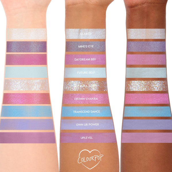ColourPop In A Trance shadow palette swatches spanning three arms, showcasing pastel purples, pinks, and icy blues in matte, shimmer, and glitter finishes; shade names like Clarity, Mind’s Eye, Daydream BBY, Future Self, and Aura Again visible.
