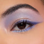 Shimmery lavender-to-blue winged eyeshadow accenting a brown eye, with an iridescent inner corner and lilac lower lash line, showcasing shades from the Disney Lilo and Stitch Collection ColourPop Full Collection Set in a close-up beauty shot.