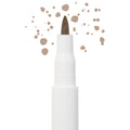 Soft Brown freckle pen by Colourpop with a fine felt tip applying natural soft brown dots, shown close up against a white background to highlight precise faux freckle makeup for the face.