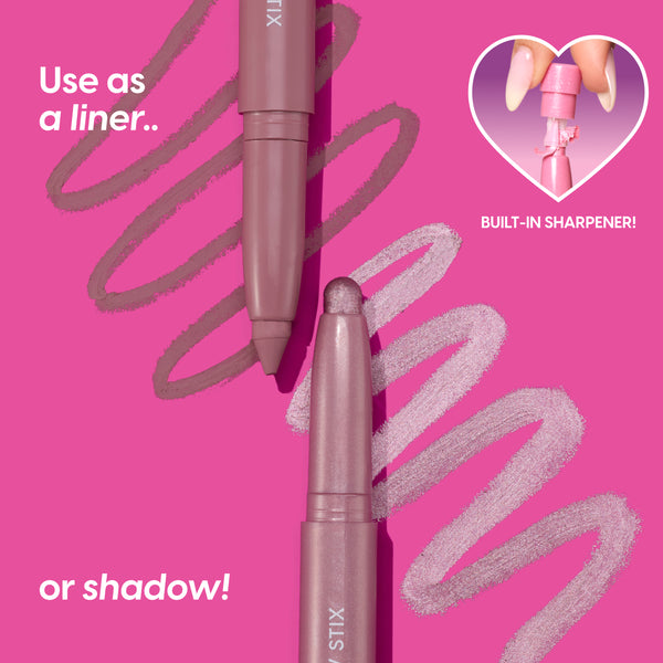 Two mauve All Eyes On Me Shadow Stix from the Heart to Get collection swipe shimmery and matte pink lines across a bright pink background, with text showing they can be used as liner or shadow and a heart inset highlighting the built-in sharpener.