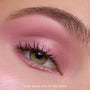 Close-up of a hazel eye wearing Heart to Get Love At First Swipe Shadow Stix, showing shimmery rose-pink eyeshadow blended from lash line to brow for a soft, romantic makeup look on smooth skin.