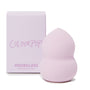 Hourglass Blending Sponge blending foundation and concealer with a pointed tip and curved hourglass grip, shown upright beside a lavender ColourPop box; soft pastel purple foam, a ColourPop Makeup Tools & Accessories staple for seamless coverage.