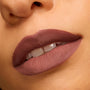 Matte mauve lips wearing Bella! Where the Hell Have You Been, Loca? Power Pout Lipstick, showing full, velvety coverage with defined edges, captured in an extreme close-up on warm skin - ideal for completing a ColourPop Lip Set.