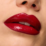 Glossy cherry-red lips showcase Pack Member ColourPop Lip Set, delivering rich pigment and a high-shine finish, captured in an extreme close-up against smooth skin for a bold, vampy look.