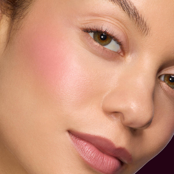 Close-up model cheek and lips wearing ColourPop Lip and Cheek Balm, showing a sheer pink flush and dewy natural finish, highlighting A Shadow of Secrets Collection Full Collection Set for a fresh everyday makeup look.
