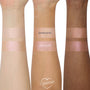 Mother Gothel ColourPop Liquid Highlighter swatched in two shimmering bands on three arms (light, medium, deep tones), showing a rosy champagne glow beside I See The Light on a white background.