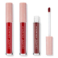 ColourPop Ultra Matte Lip Major Hottie set stands upright, two closed tubes and one open showing a doe‑foot applicator coated in deep red, blush‑pink star‑print caps, studio product shot on a white background.