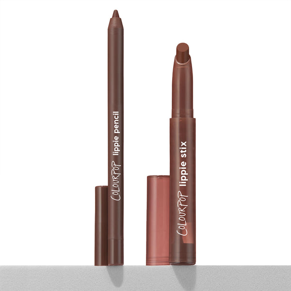 ColourPop Lippie Stix + Pencil Set Lip Service shown uncapped, liner pencil and twist-up lippie stix in warm brown standing upright with caps beside them on a light surface, showcasing a creamy duo for precise lining and full lip color.