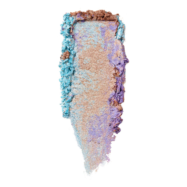 Ohana ColourPop Super Shock Highlighter swatch shimmers in a vertical smear of champagne gold with iridescent shifts of aqua blue and lavender purple, crushed along the edges on a white background, showcasing its high-shine cream-to-powder payoff.