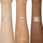 ColourPop Super Shock Highlighter in Ohana swatched in wide stripes on three forearms (light, medium, deep), revealing a pink champagne shimmer with smooth, high-shine payoff; center swatch labeled OHANA on a clean white studio background.