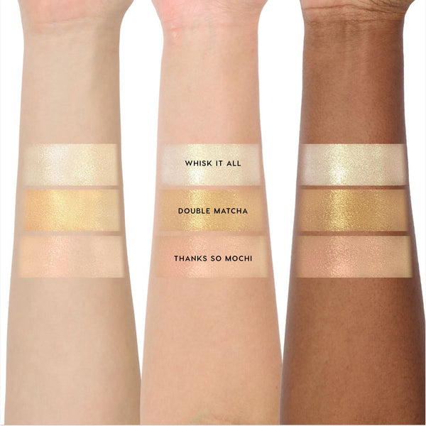 Three arms in light, medium, and deep skin tones display swatches of the Sweet Sips full collection set Super Shock Shadow shades Whisk It All, Double Matcha, and Thanks So Mochi, showing shimmery champagne and golden hues side by side.