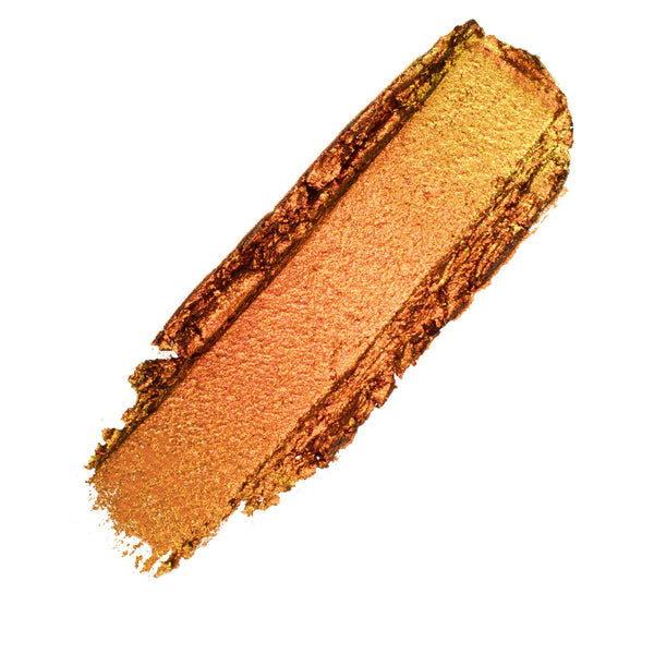 Wolf Girl ColourPop Shadow Stix eyeshadow swatch, dragged in one swipe to show a smooth metallic copper-gold shimmer with warm orange undertones and textured edges on a clean white background.