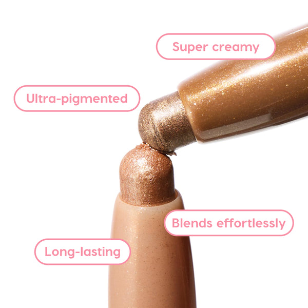 Shimmering Golds Shadow Stix in metallic gold, two rounded tips touching to show a super creamy, ultra-pigmented formula that blends effortlessly and lasts long, ColourPop Shadow Stix on a white background with feature callouts.