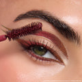Dragon’s Keep ColourPop Crème Gel Liner defining a metallic ruby wing, framing a green eye as a burgundy wand brushes through the brow; rich red shimmer shifts to copper along the lower lash line for a bold, long-wear look.