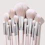Stone Cold ColourPop Makeup Brush Kit fanned upright, displaying powder, blush, contour, and eye brushes with fluffy blush-pink bristles, silver ferrules, and pale pink handles, stacked tightly against a soft beige backdrop.