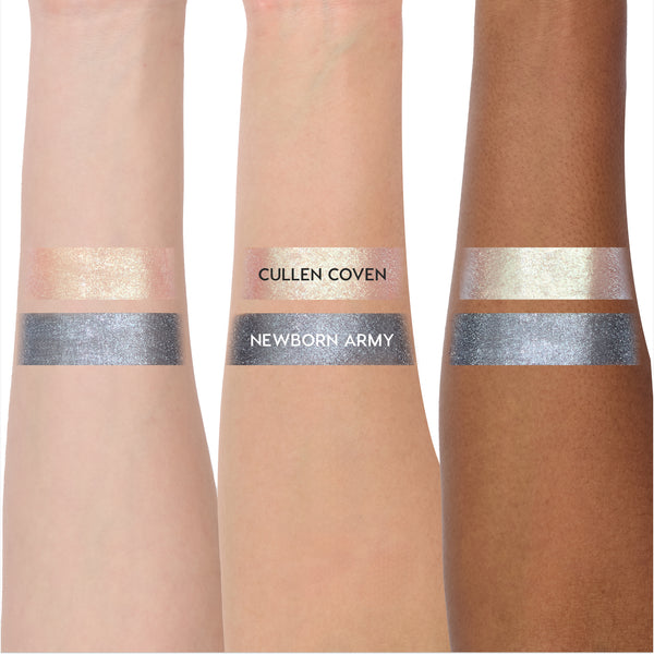 Coven Clash Jelly Much Duo Twilight collection swatched on three arms, showing shimmery pale gold Cullen Coven and metallic steel gray Newborn Army shades with opaque, reflective payoff across light to deep skin tones.