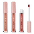Warmed Up ColourPop Ultra Matte Lip set shows three full‑size tubes with peach star caps and one open doe‑foot applicator, revealing warm terracotta and deep reddish‑brown nude shades arranged on a clean white background.