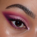 Shimmering pink-to-plum smokey winged eye created with the Total Smokeshow ColourPop Shadow Palette & Brush Set, showing blended metallic and matte shades, crisp inner-corner highlight, fluttery lashes, and a defined brow in close-up studio lighting.