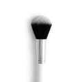 Large Powder Brush poised to sweep loose or pressed powder across the face, with a rounded dome of dense black-to-white bristles, a polished silver ferrule, and a white handle; ColourPop makeup brush on a clean white background.