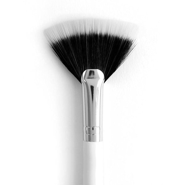 ColourPop Fan Brush makeup brush fanning black-to-white bristles to sweep highlighter and gently remove fallout, shown close-up with a chrome ferrule and glossy white handle on a clean white background.