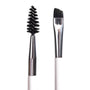 ColourPop Brow Dual Ended Brush makeup brush shaping and defining eyebrows, featuring a black spoolie on one end and an angled flat brush on the other with silver ferrules and a white handle, shown in a studio close-up on a white background.