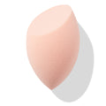 Peach teardrop Blending Sponge with a flat slanted edge resting at an angle, showing fine foam texture for seamless foundation and concealer blending, isolated on white with soft shadow; a must-have in ColourPop Makeup Tools & Accessories.