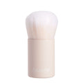 Mini Kabuki Face Brush with dense white bristles and a matte beige short handle branded ColourPop stands upright, ready to buff and blend foundation or powder; compact ColourPop Makeup Brush on a clean white background.