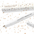 Soft Brown ColourPop Freckle Pen uncapped, felt-tip applicator ready to dot natural-looking freckles, shown with polka-dot cap and matching box on a white background speckled with brown spots; 1.0 ml makeup pen for faux freckles.
