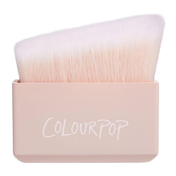 ColourPop Angled Sculpting Brush stands upright, showcasing dense slanted synthetic bristles fading blush to white in a soft pink rectangular handle with logo, studio-lit on white - a precise ColourPop Makeup Brush for contour and highlight.