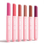 Six ColourPop So Juicy Plumping Gloss Balm with Peptides sticks, So Balm, stand upright and uncapped on a white background, displaying fuchsia, coral, rosy nude, beige, warm brown, and deep berry in pink tubes labeled SO JUICY.