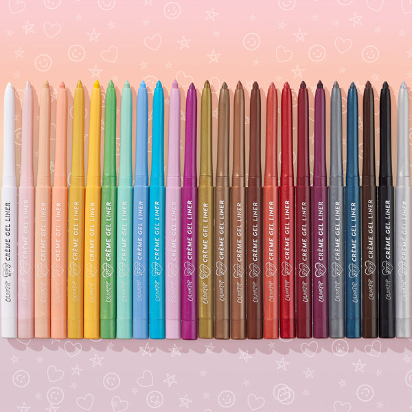 ColourPop Crème Gel Liner pencils stand upright in a rainbow row, highlighting the vivid cobalt Out of the Blue shade with tips extended, set against a pink gradient background with playful stars, hearts, and smiley doodles.