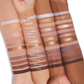 11:11 ColourPop Shadow Palette arm swatches - 12 matte and metallic eyeshadows, from Total Angel (icy silver) to Divine (deep brown) - striped on three skin tones with shade names labeled, photographed on a clean white background.