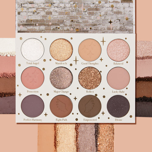 11:11 ColourPop Shadow Palette opens to 12 pans in a white case with gold stars, showing warm neutrals and pinks in matte and glittery metallic finishes, with crushed swatches above and below on a peach backdrop; shades include Reflect and Divine.