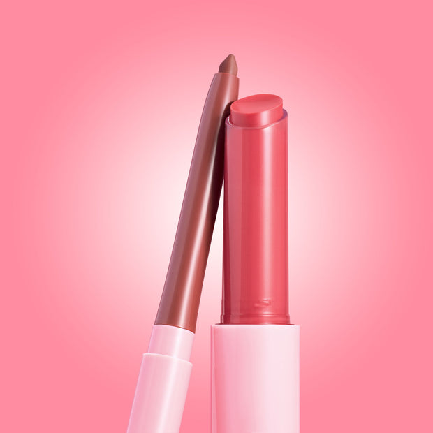 Rosy nude twist-up lip liner leans against an open glossy pink balm in sleek pink tubes on a gradient pink background; Glazed Pout ColourPop So Juicy Plumping Lip Liner & Balm Set showcasing the plumping duo for fuller-looking, shiny lips.