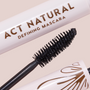 Mascara wand coated in deep black formula defining dense bristles, shown beside a blush-pink tube reading ACT NATURAL; ColourPop Act Natural Mascara, Black shade, with bronze detailing on the cap, close-up product shot on a neutral background.