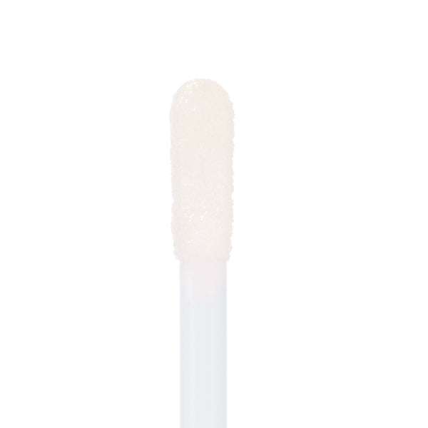 Soft doe-foot applicator coated in 20 Carats Ultra Glossy Lip glides on clear, micro-shimmer shine, captured in macro on a white background to show the plush tip and wet look - ColourPop Ultra Glossy Lip.