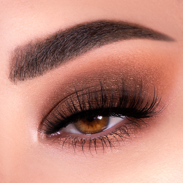 Warm neutral smoky eye showcases Nude Mood ColourPop Shadow Palette, with matte taupe and chocolate blended in the crease, copper shimmer on the lid, long black lashes, and a defined brow in a close-up beauty shot.