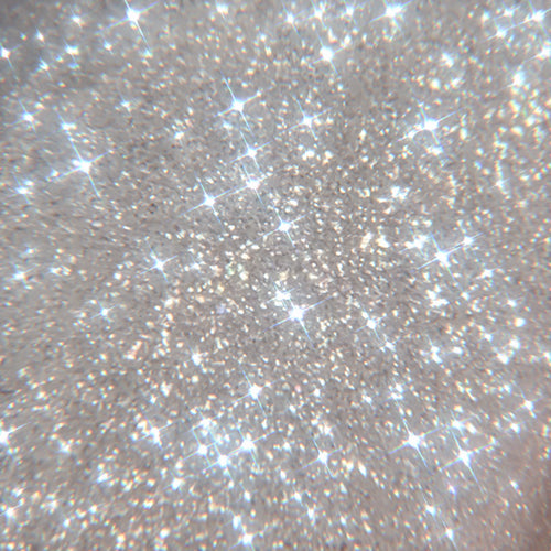 Sterling Silver shade of ColourPop SOL Shimmering Dry Oil sparkling in a close-up texture swatch, fine silver micro-shimmer catching light with starburst highlights to show the high-gloss, glowy body oil finish.