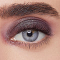 Shimmery plum eyeshadow sweeps across the eyelid, showcasing ColourPop Bae Super Shock Shadow on a close-up eye with defined lashes and brow, highlighting metallic sparkle, smooth blend, and rich payoff for a bold evening makeup look.