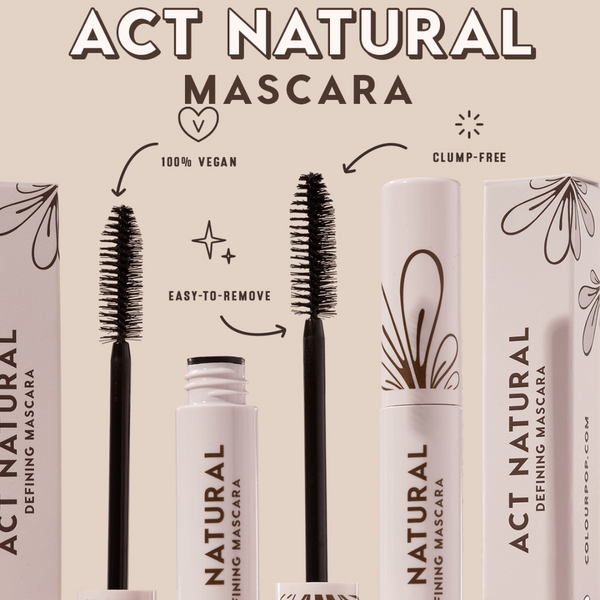ColourPop Act Natural Mascara in Black defining lashes with a tapered bristle brush; open white tube and wand displayed beside closed tube and boxes with floral graphics; claims shown: 100% vegan, clump-free, easy to remove; studio beige backdrop.