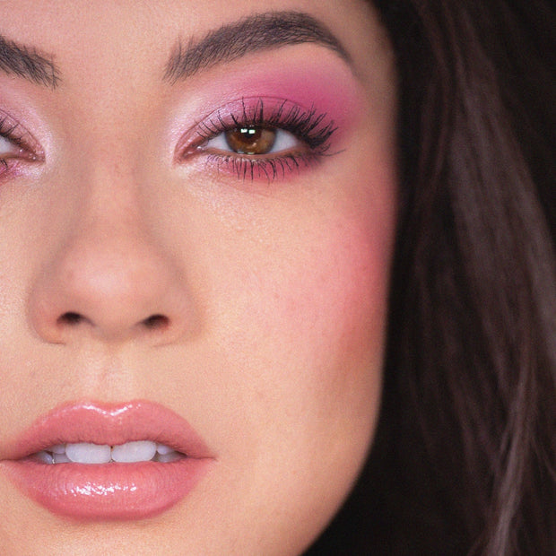 Cloud Baby shades from the ColourPop Shadow Palette Set swept across lids in pastel pink shimmer with deeper rosy outer corners, emphasizing brown eyes and long lashes, paired with glossy nude lips in a tight beauty close-up.