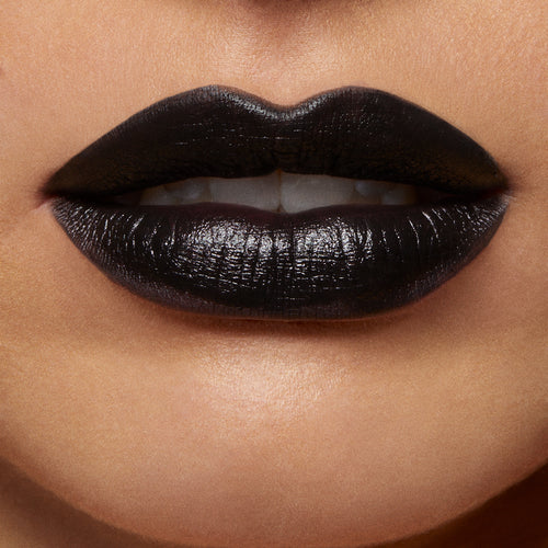 ColourPop Lippie Pencil in Bull Chic lines and fills lips in opaque true black with a soft satin sheen, shown in a tight beauty close-up displaying crisp edges and full coverage.