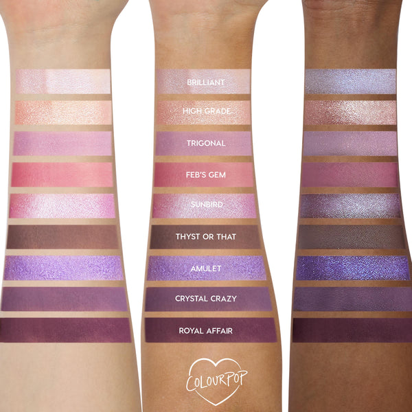 Arm swatches show the All Amethyst ColourPop Shadow Palette on three skin tones, displaying nine lilac, pink, and deep plum shades in matte and shimmer - e.g., Brilliant, Feb’s Gem, Royal Affair - with labeled stripes for color payoff comparison.